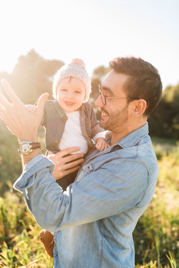 Happy man holding a baby