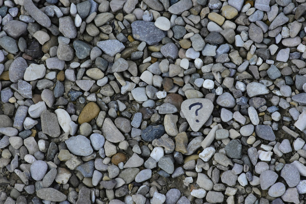 Question mark on a rock